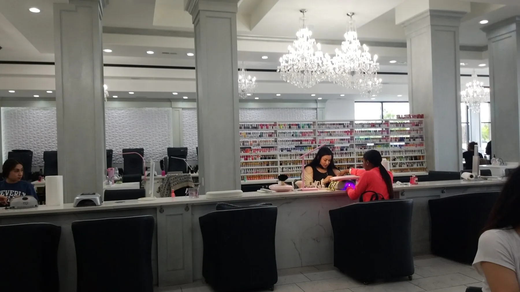 Guests and nail artists along the manicure bar at the Rockford flagship