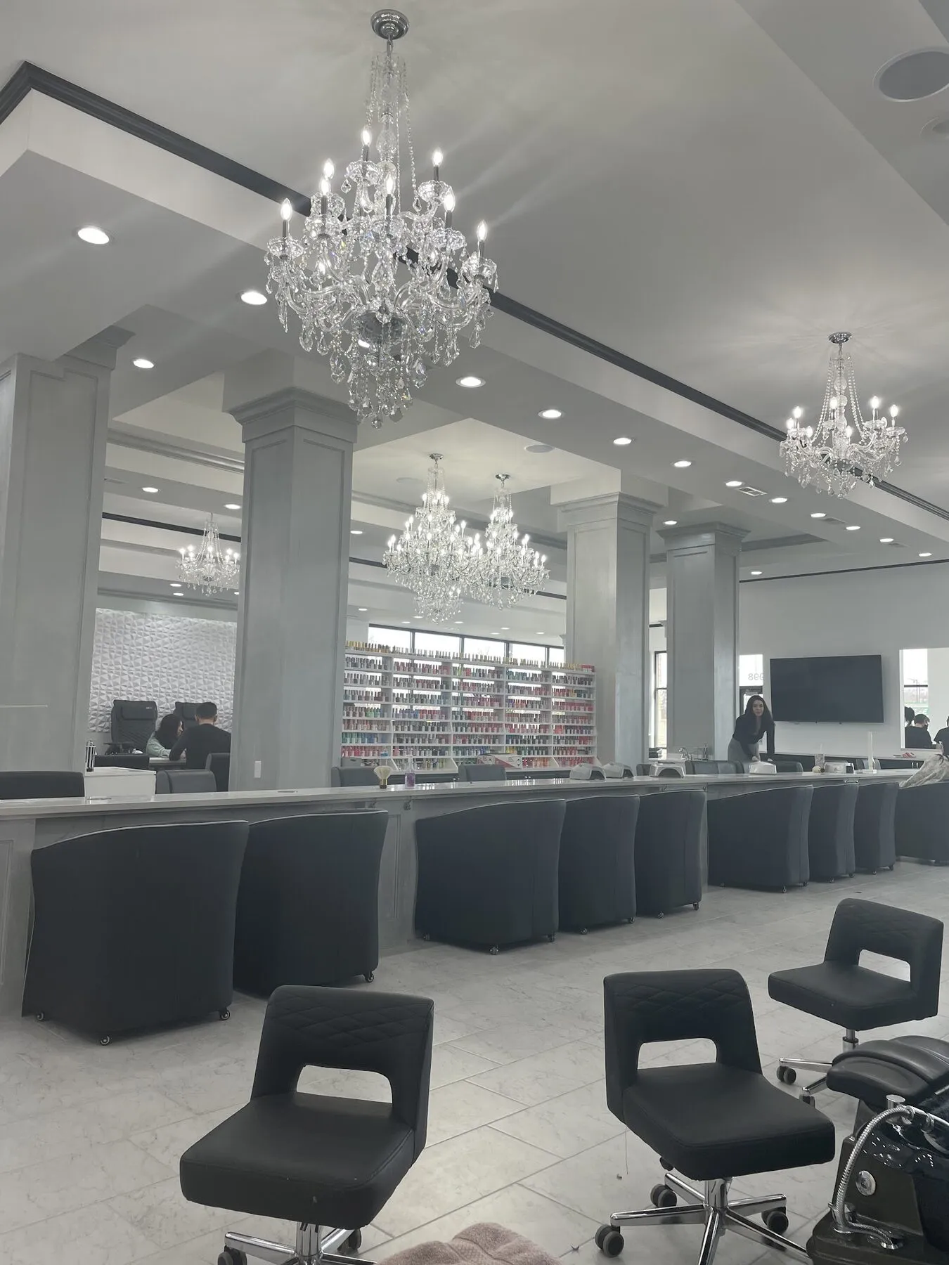 Crystal chandelier and towering polish display in the Rockford salon