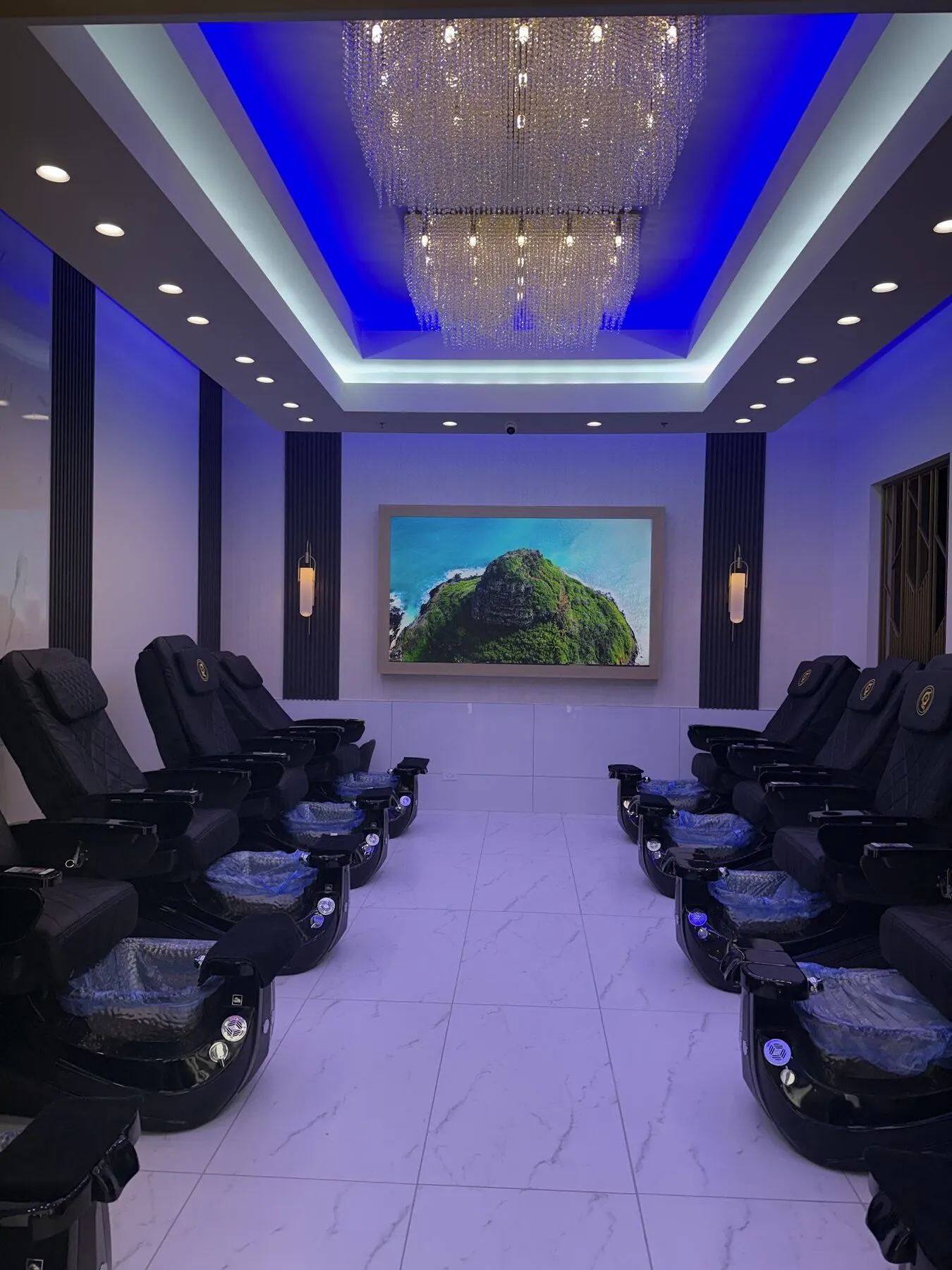 Symmetrical row of spa pedicure chairs under soft ambient lighting