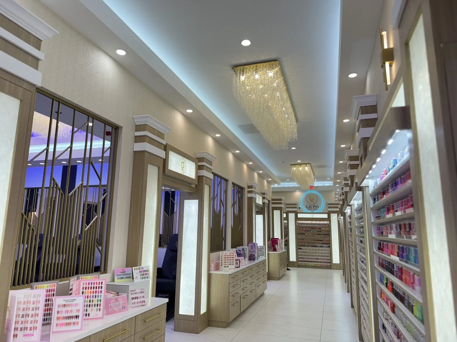Entrance and backlit polish display with press-on nail collections at Gloss Nail Bar Machesney Park