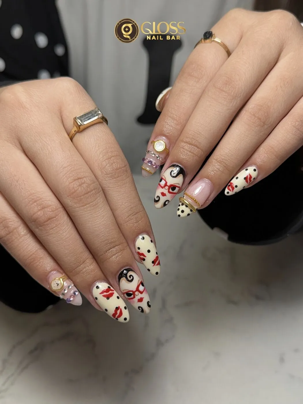 Playful cream almond nails with polka dots, red lips and hand-painted retro faces