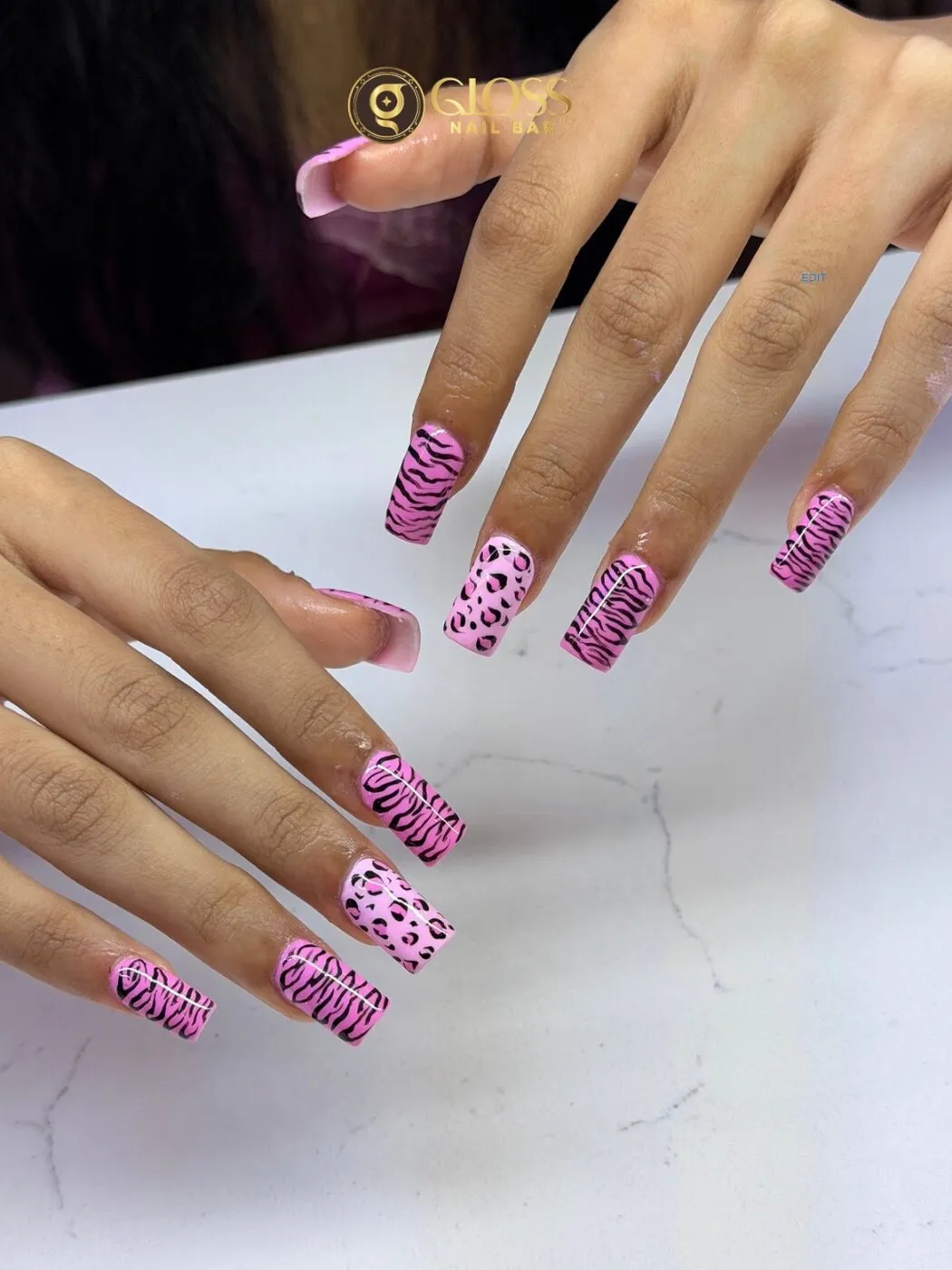 Bubblegum-pink square nails stamped with zebra and leopard animal prints