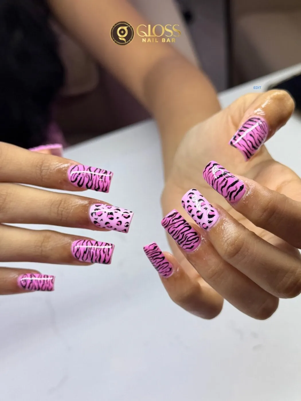 Pink animal-print manicure mixing tiger stripes and leopard spots