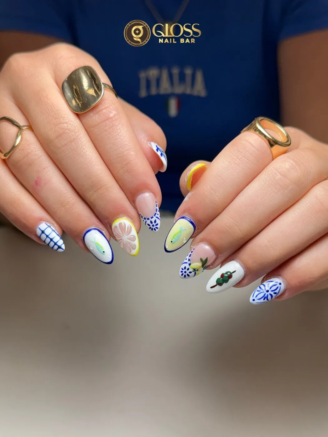 Mediterranean-inspired almond nails with majolica tile art, lemons, olives and little fish