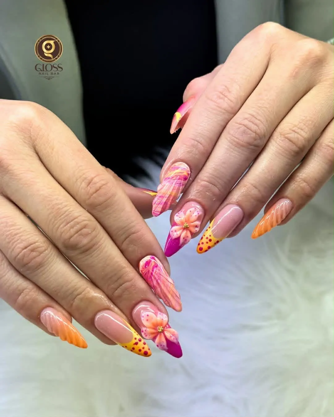 Sunset pink-and-orange ombré stiletto nails with 3D hibiscus flowers and magenta tips