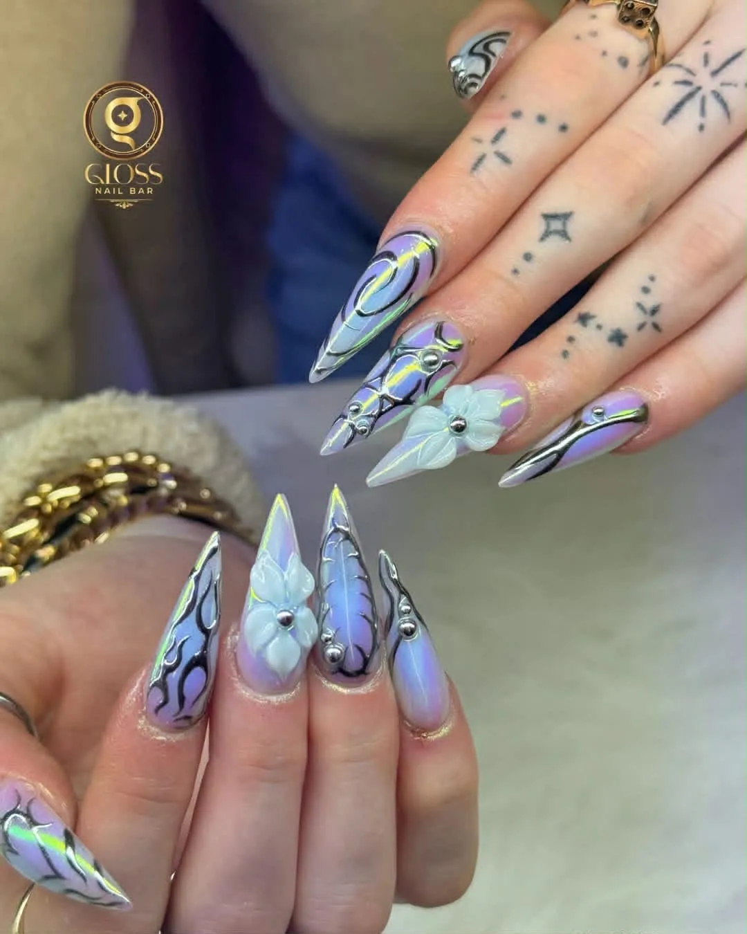 Lavender aura nails with silver chrome swirls and 3D white lily flowers