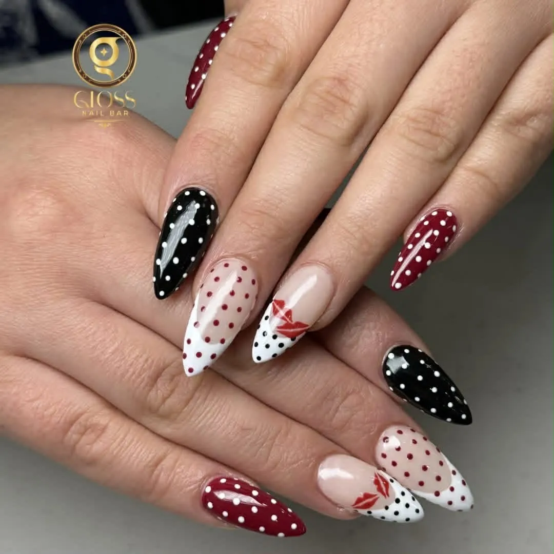 Black, red and white polka-dot almond nails with hand-painted red lips